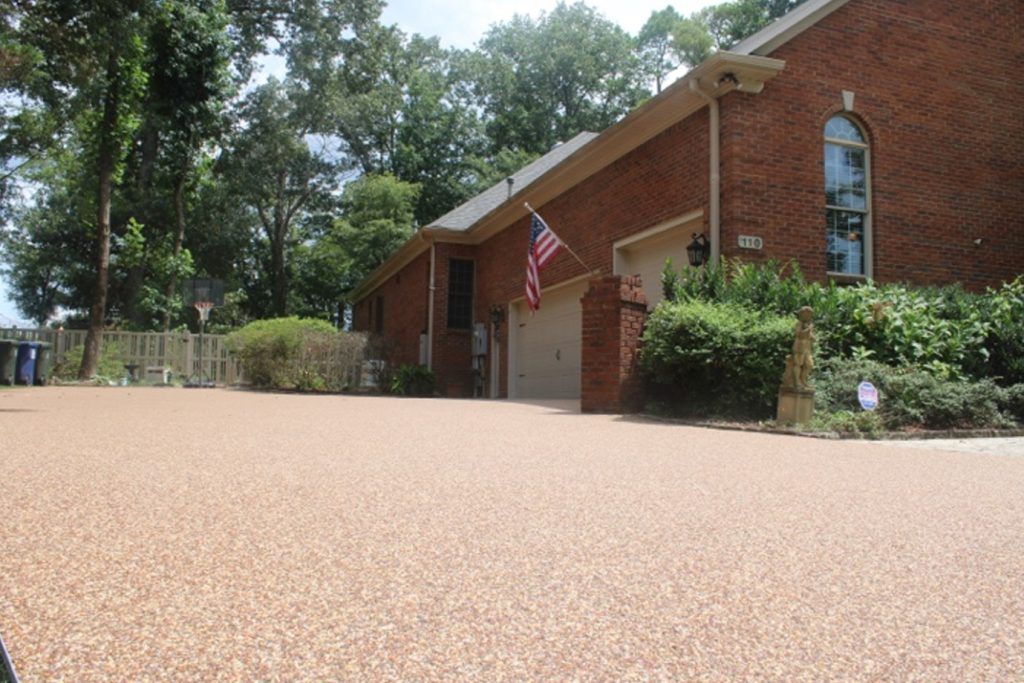 ACE Resin driveway beside brick home